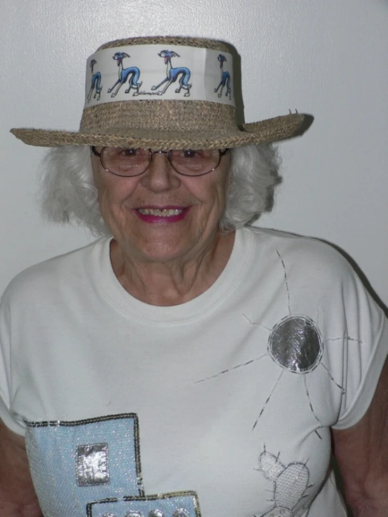 a woman with glasses and a white hat on