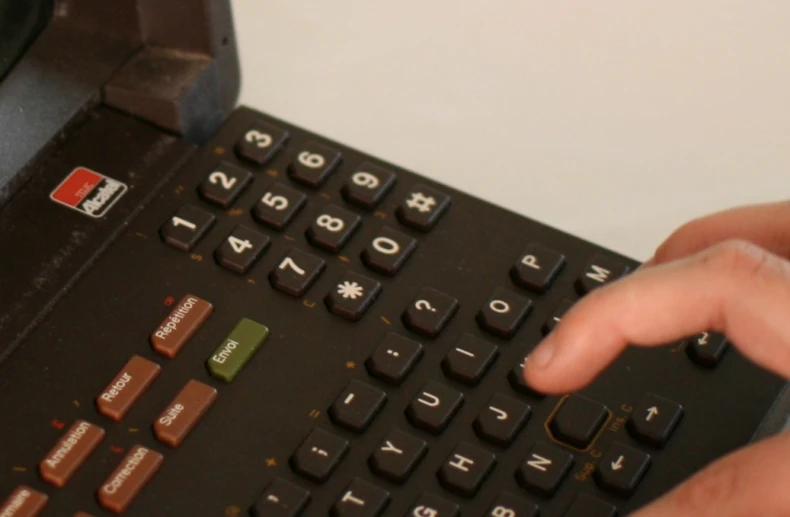 hands on a keyboard and some writing is on the keyboard