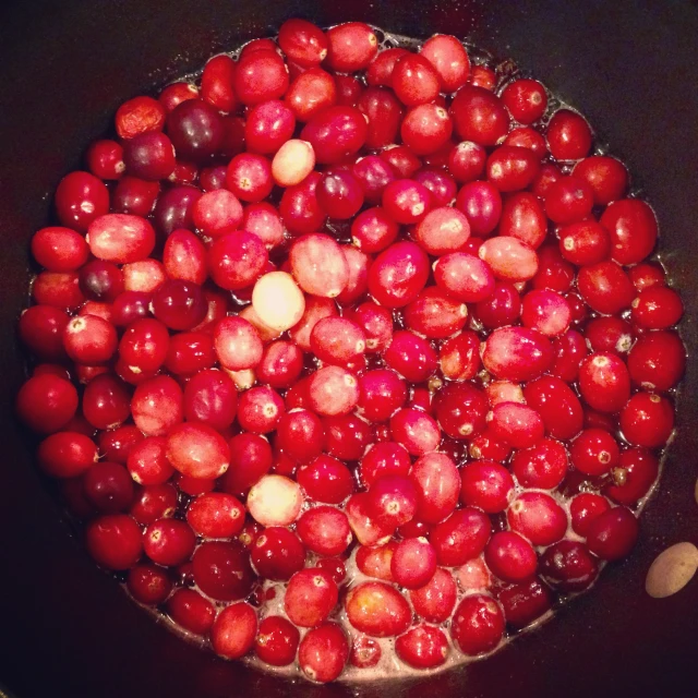 cranberries and potatoes are cooking in a saucer