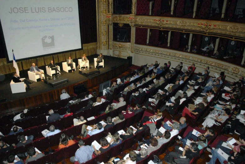 an audience watching a seminar on a large screen