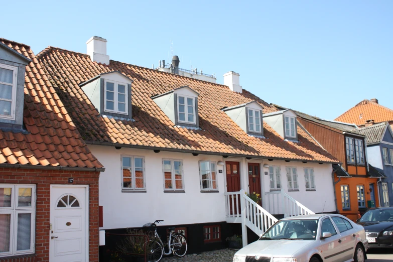 some cars parked in front of white houses