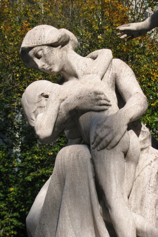 a statue of two people holding each other