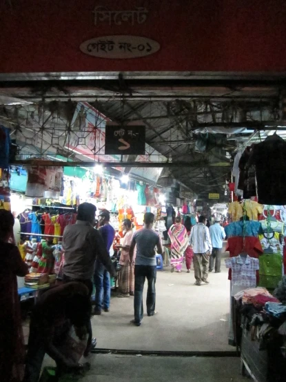 a busy market in india with vendors and people standing around