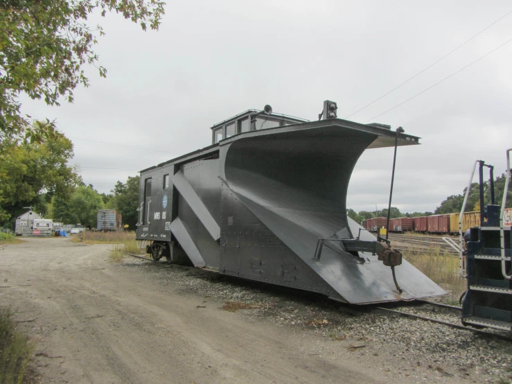 an artistically designed vehicle parked on the train track