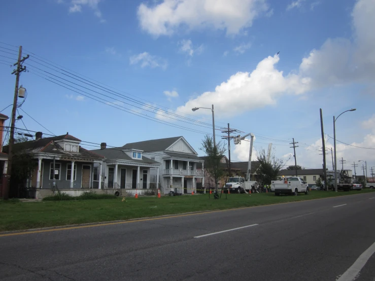 two long white house with multiple driveways sitting in front of it