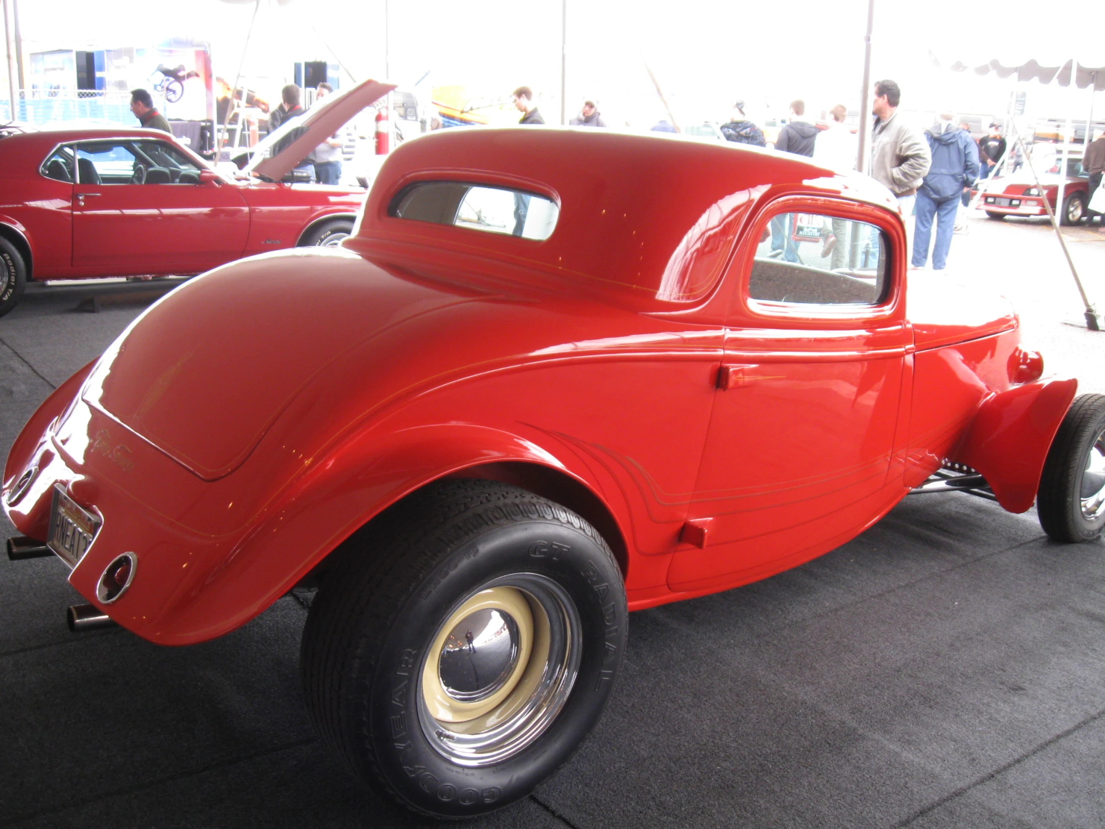 an old model red truck parked in a lot