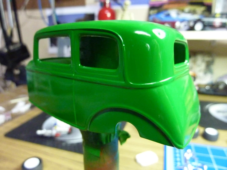 green plastic model truck with small hole in middle