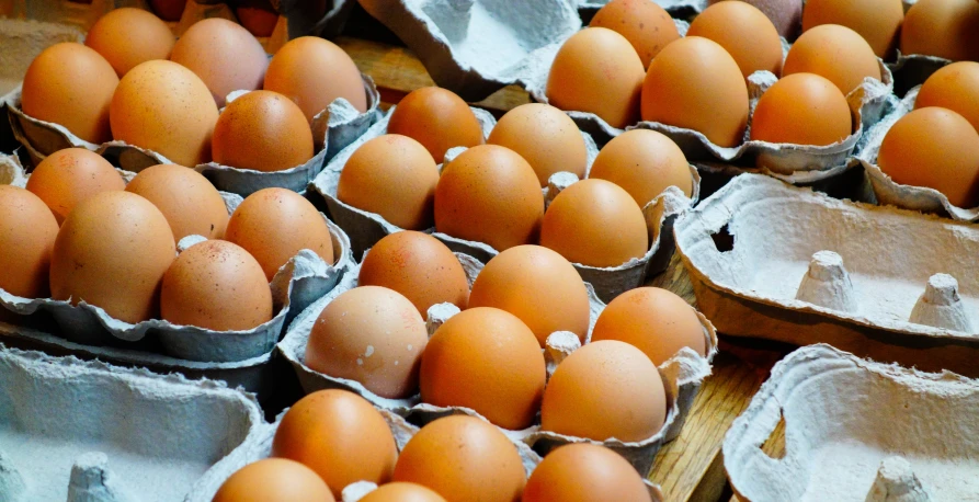 a table topped with lots of brown eggs