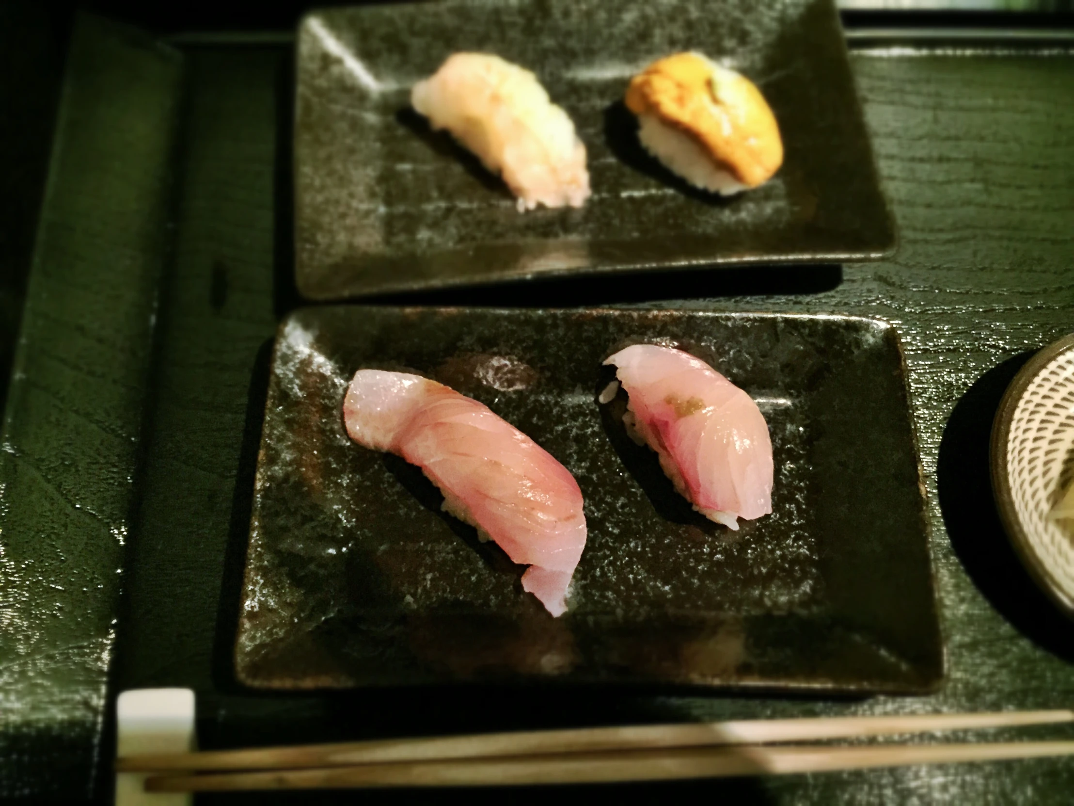 sushi is being served with chopsticks on the side