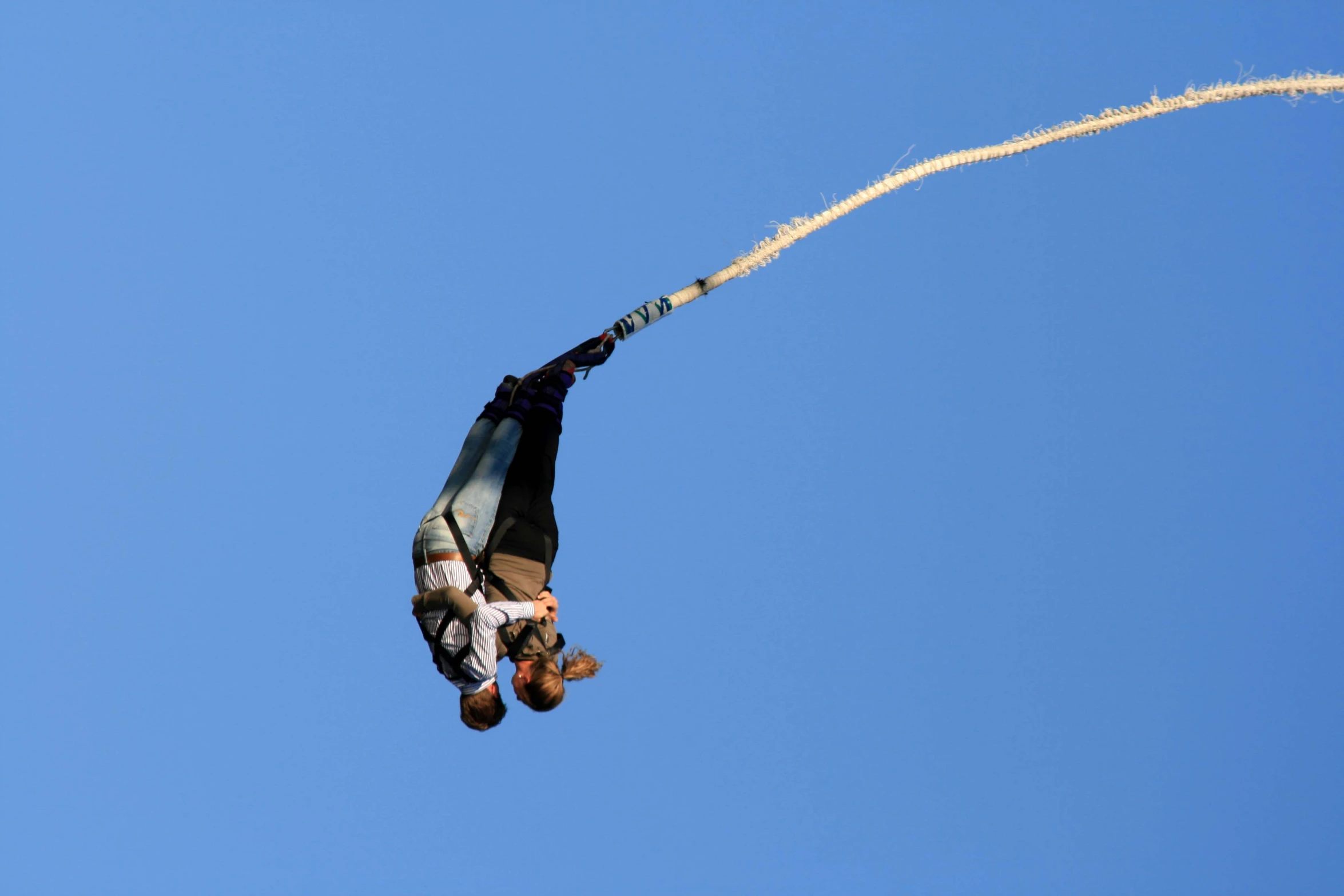 a man flying through the air while suspended from a kite