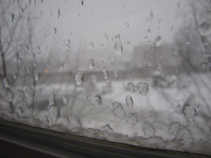 water droplets fall on the glass of a window