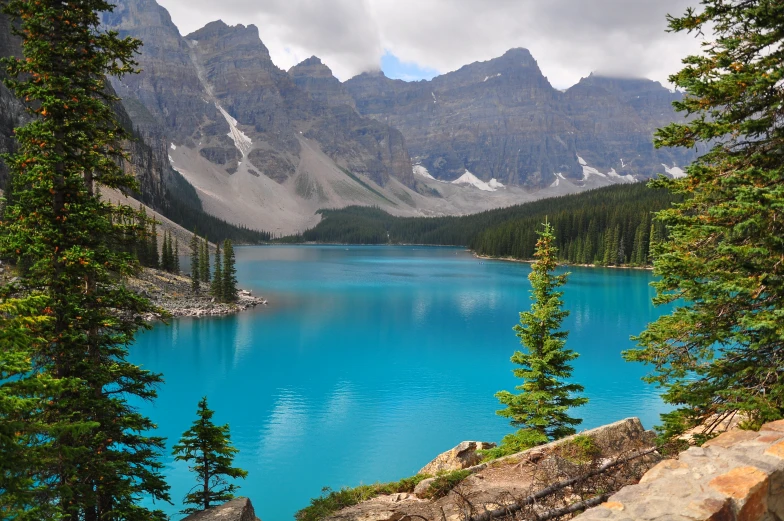 water that is surrounded by trees and mountains