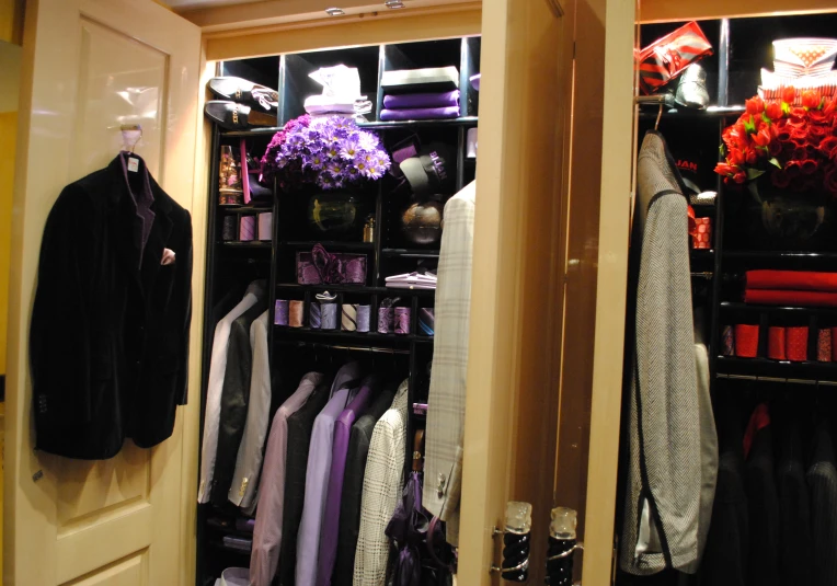 a well - arranged closet filled with mens clothes and accessories