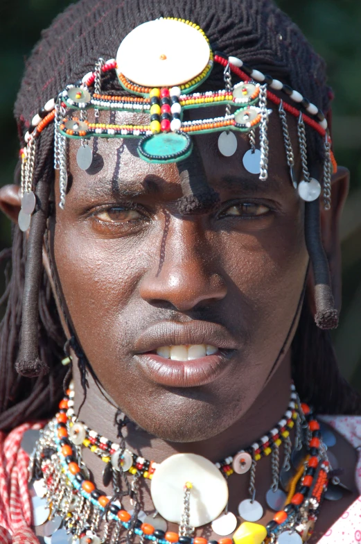 a man is dressed up with beads and beads