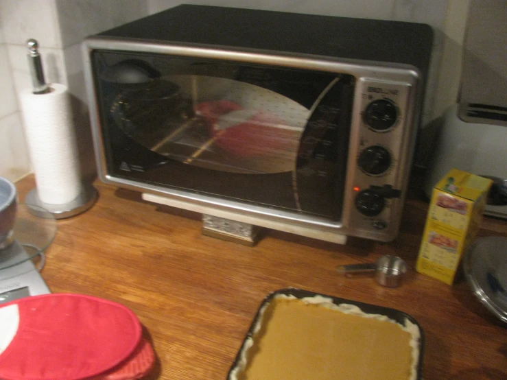 a metal oven with a brown crust in it