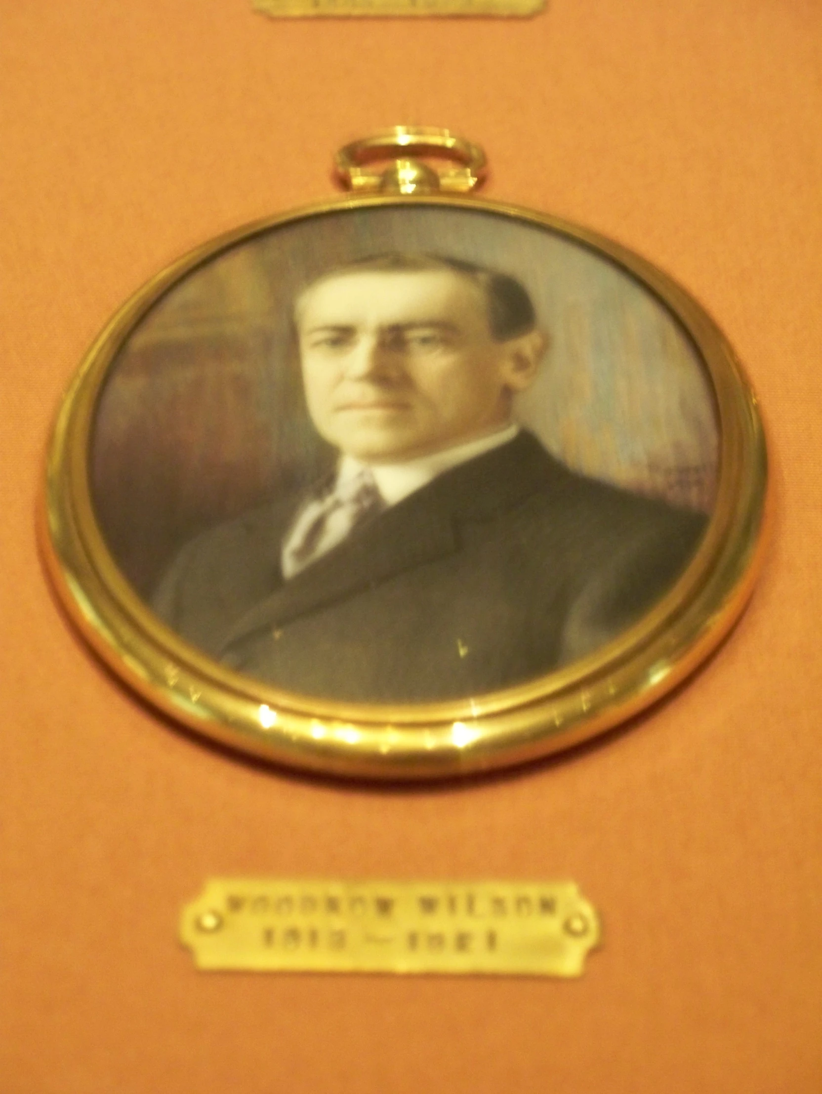 a gold plated frame with an antique po