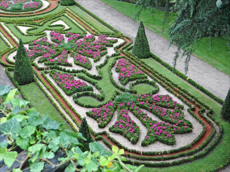 the beautiful flower garden is situated among a lot of trees