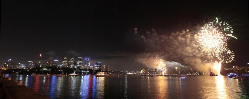 fireworks are lit up above the city skyline