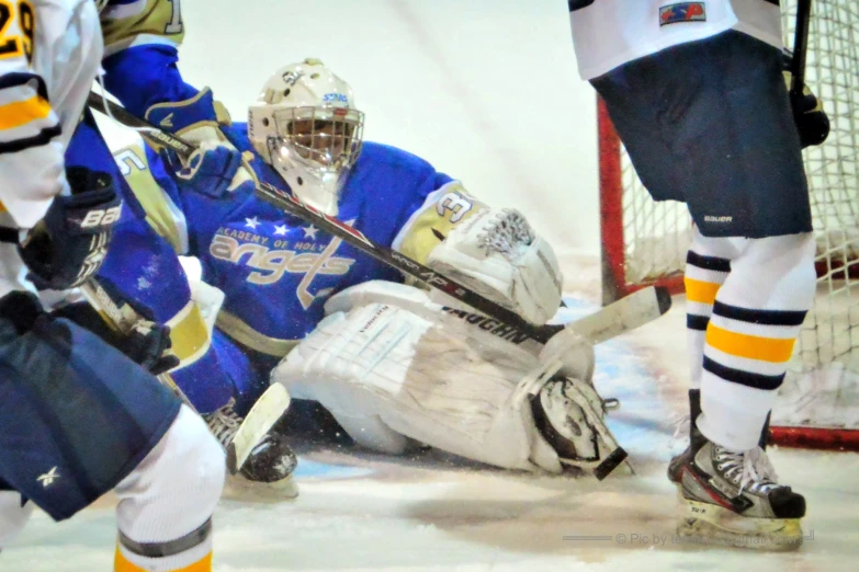 hockey players are playing a game of ice hockey