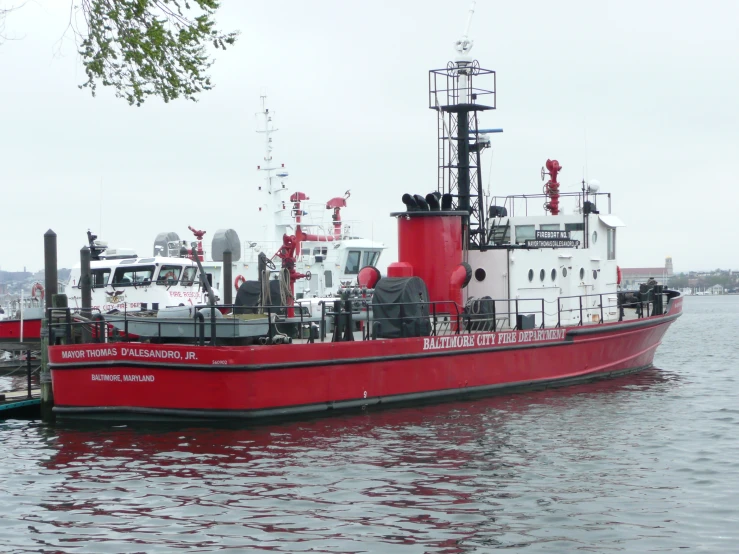 a large boat on the water has two smaller boats