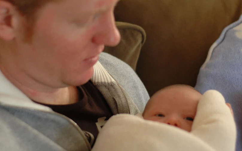 a woman holding a baby in her arms