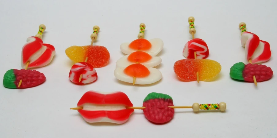 a white counter topped with candy candies and lollipops