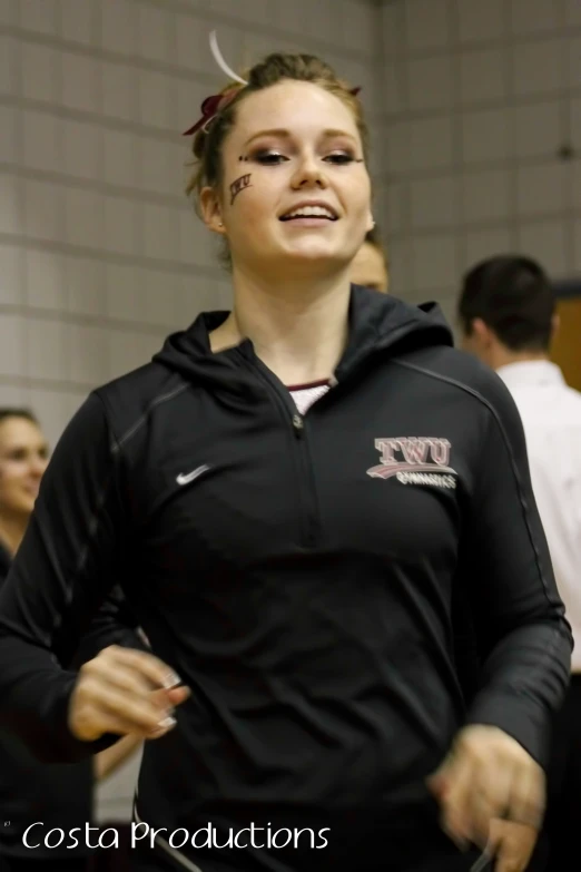 a female in black sweatshirt with an odd face paint