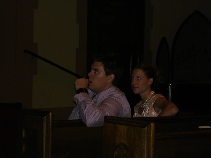 two people stand in a church and look off into the distance