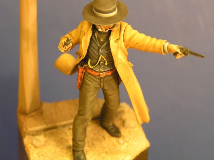 a toy with a coat, fedora, trench and hat on top of a counter