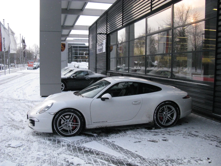 two porsches parked in front of some buildings