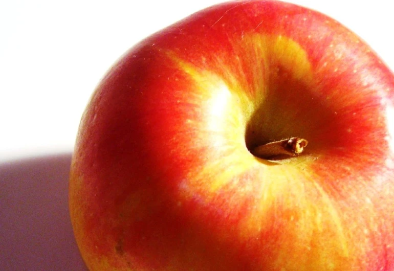 a apple is shown with the green stem