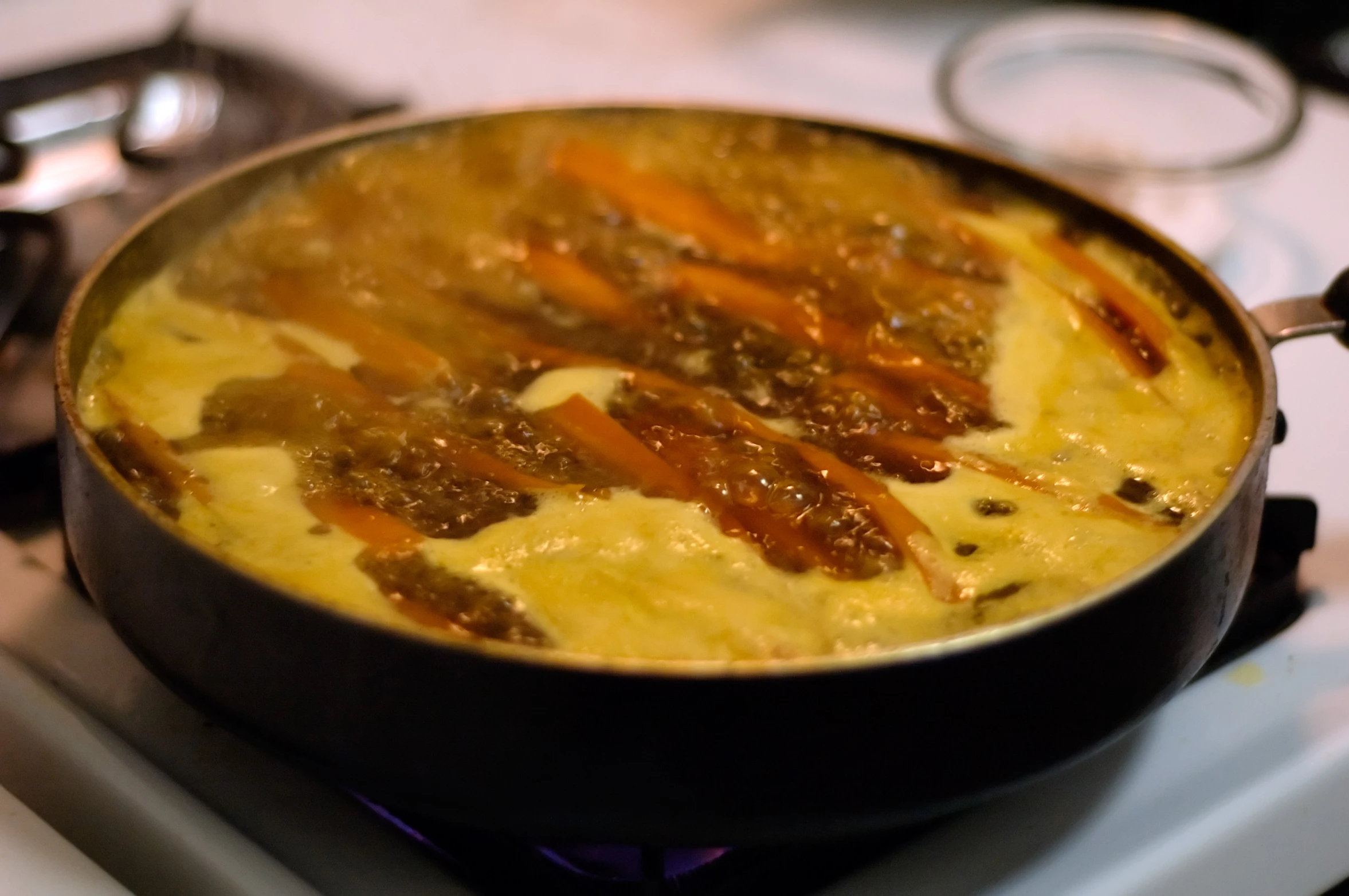 cooked food being stirred over the stove top