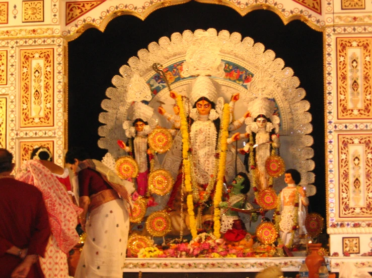 a crowd of people watching an artfully decorated statue