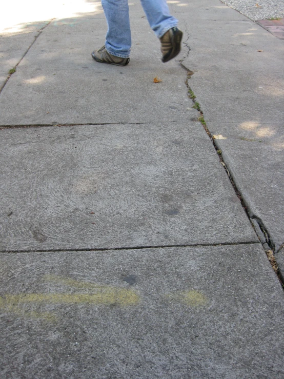 a person walking on sidewalk with no shoes