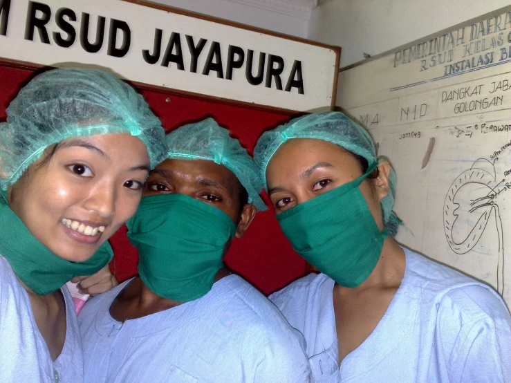 three women wearing surgical masks in the hospital