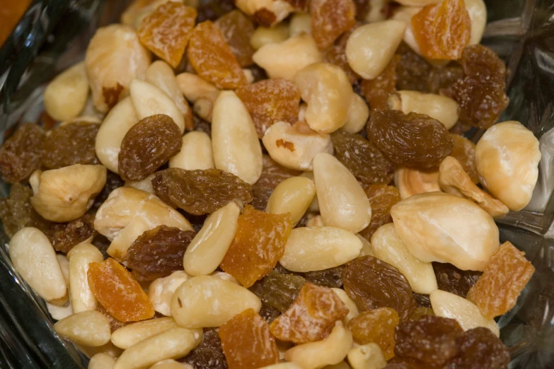 some raisins, nuts, and almonds in a clear bowl