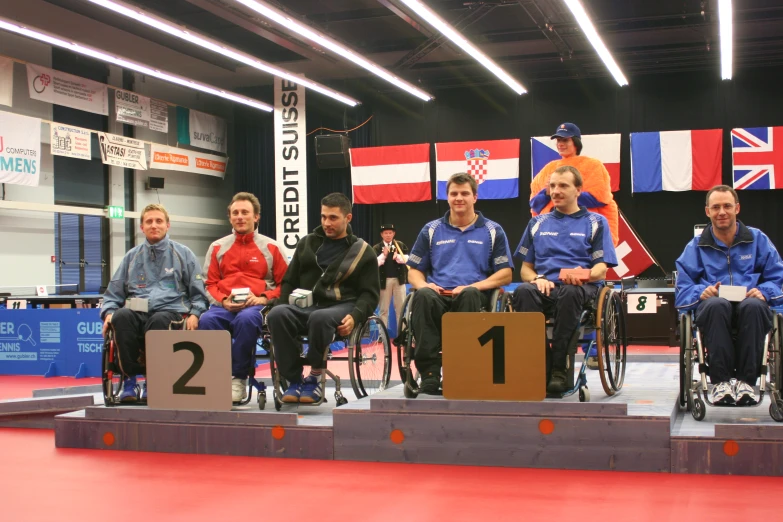 men and women who are in wheelchairs standing on stage