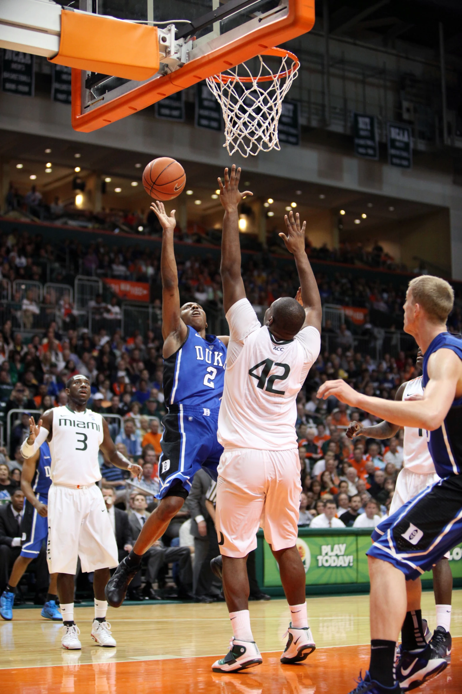 several basketball players are attempting to get the ball out