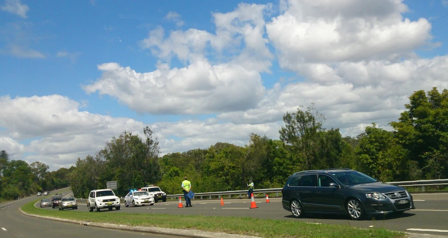 cars and men on the road during construction work