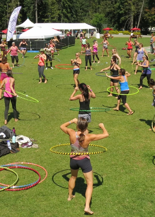 some people are playing hula hoop in the park