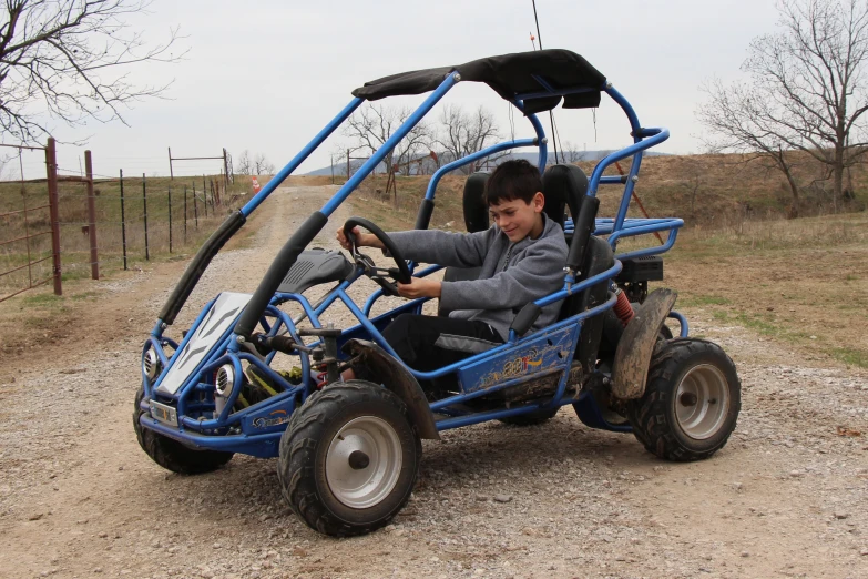 the young man is driving his go cart