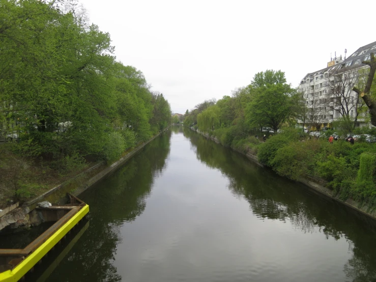 a small canal near a tree lined residential neighborhood