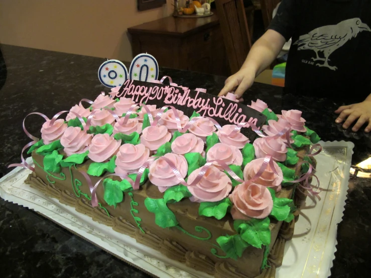 there is a sheet cake decorated with flowers on the table