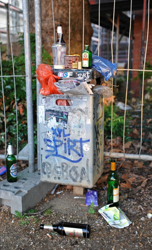 a garbage can sitting on the side of a road