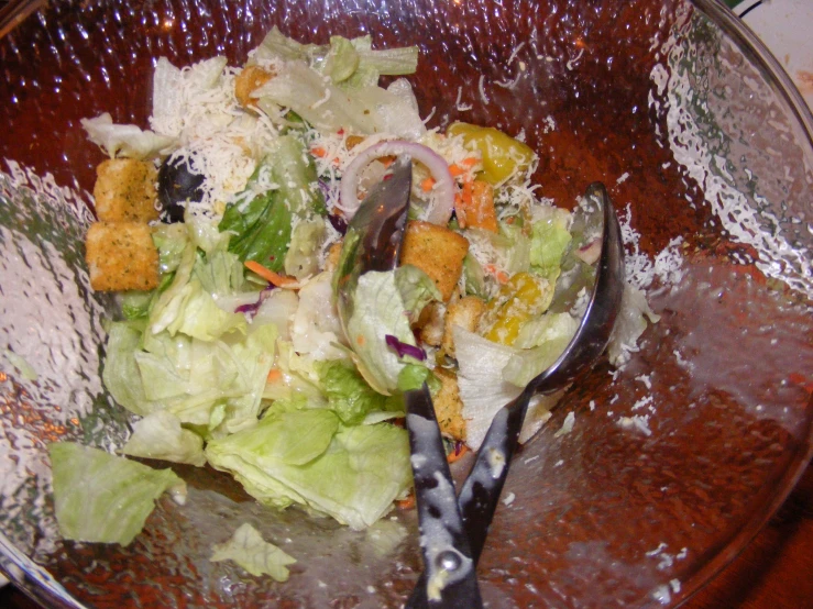 a bowl with a salad on it with a fork in it