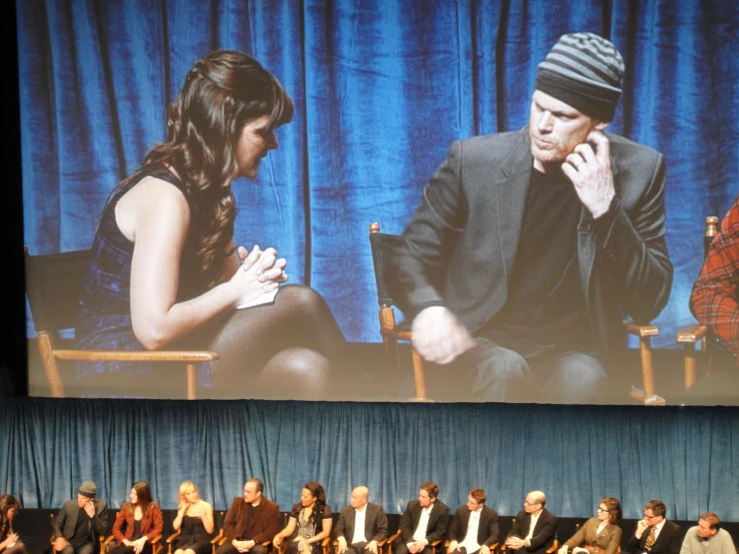 a movie panel with a group of people on stage