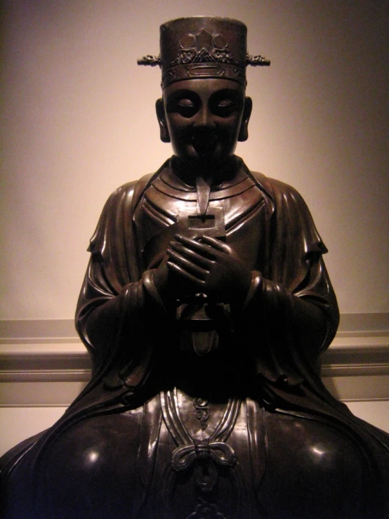 the buddha statue is holding a prayer with his hands