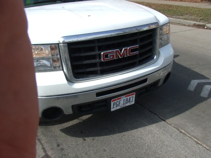 the gmc truck is parked on the curb