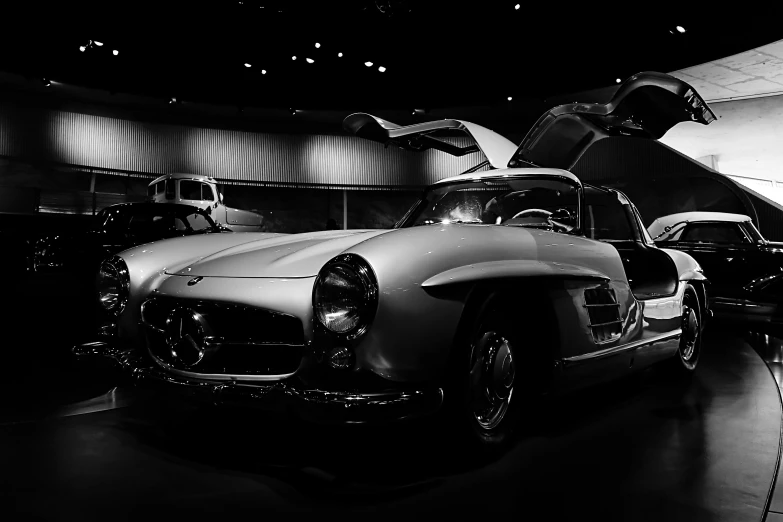 a vintage car sits on display in a museum