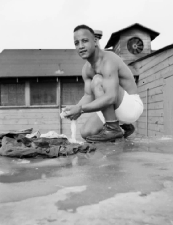 a black and white po of a man sitting on the roof